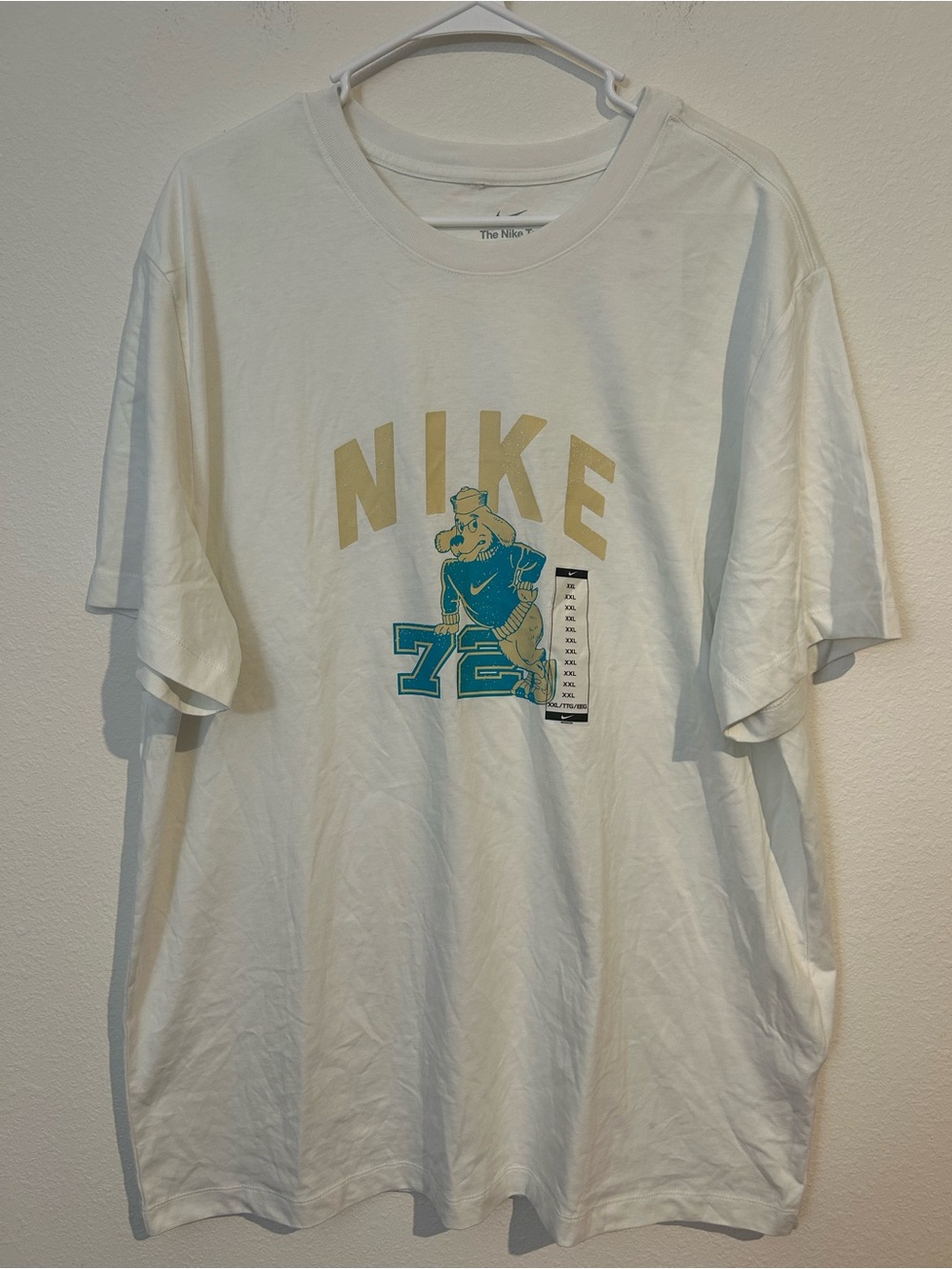 Nike White Tee with Gold Logo and Teal Mascot Graphic